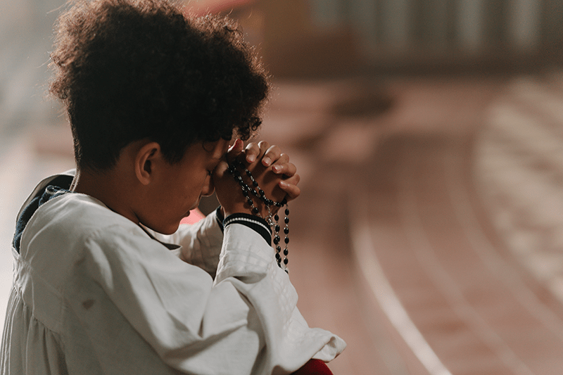 Woman praying rosary